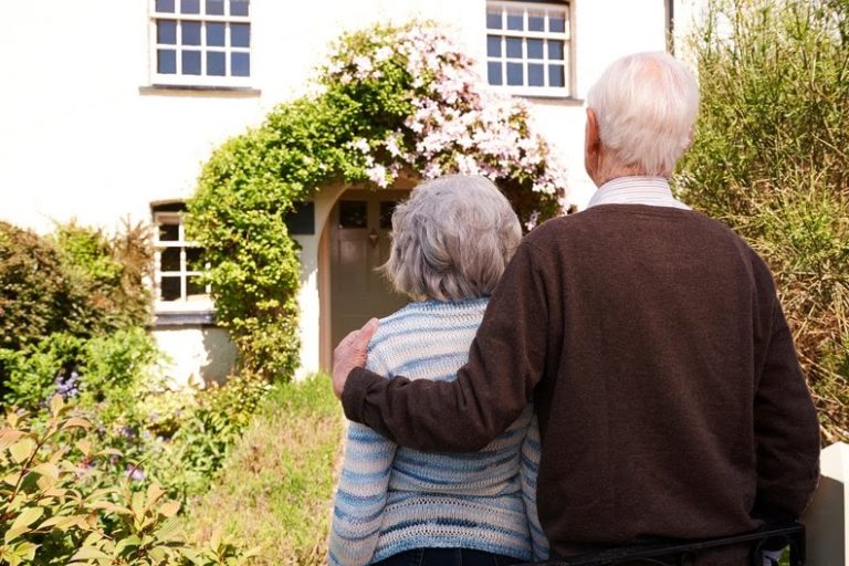 Senior couple looking at their nice house