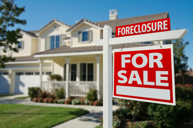 Foreclosure sign in front of suburban home
