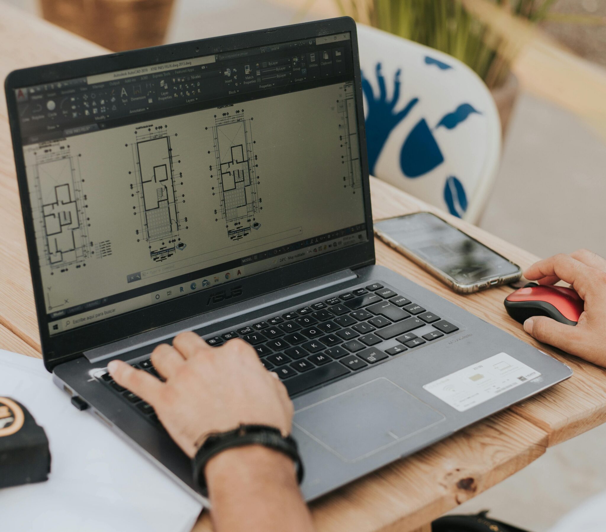A man using a construction takeoff software on a laptop.