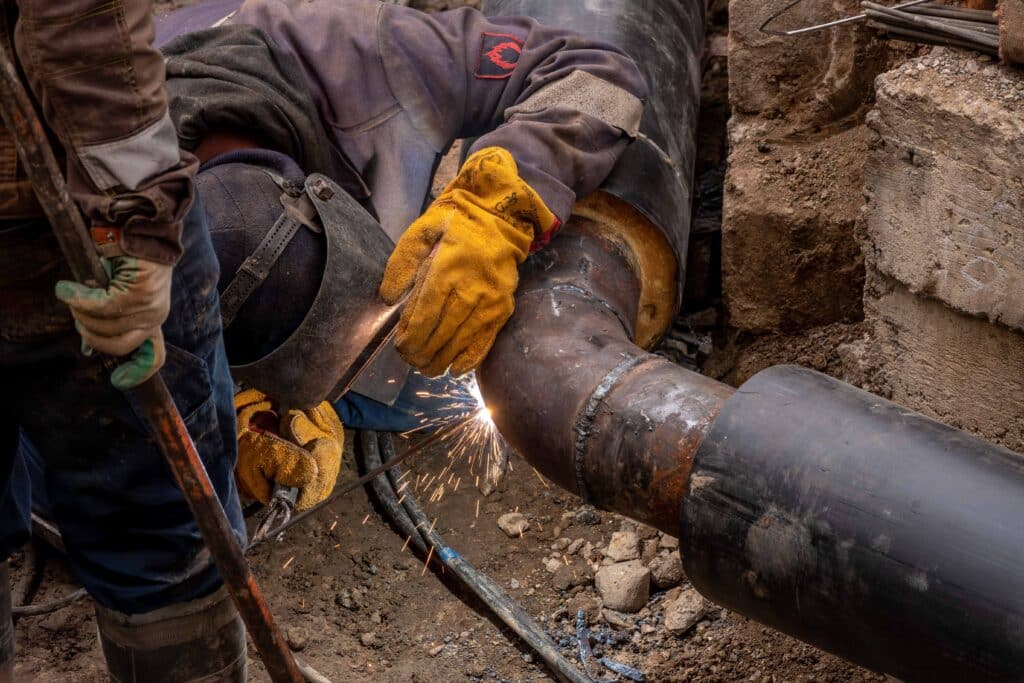 Subcontractor performing welding a plumbing line