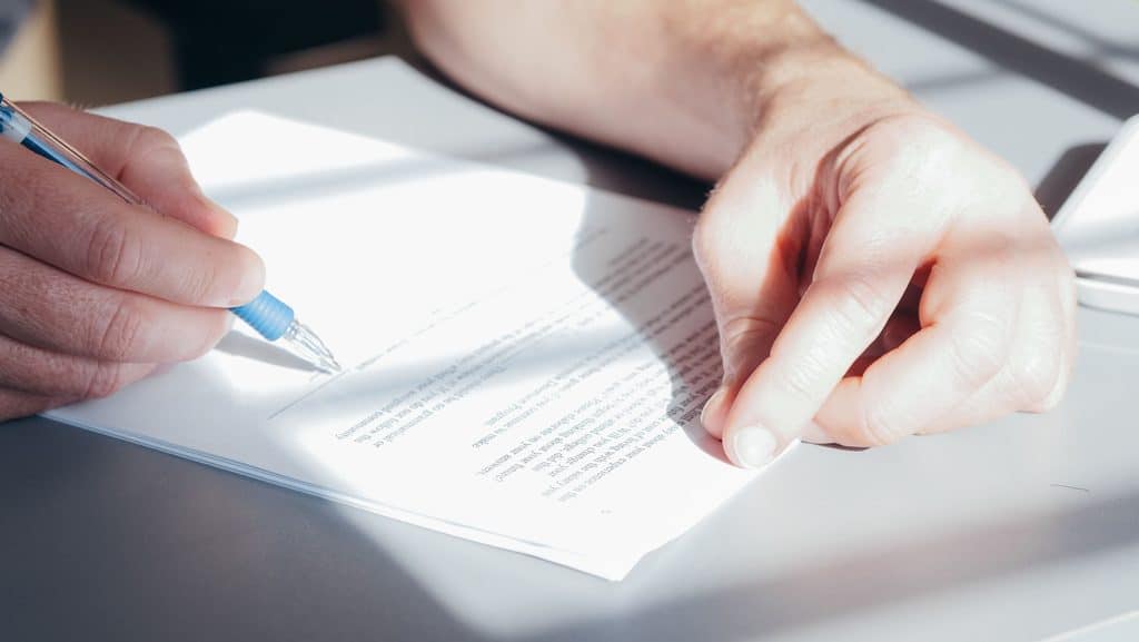 Person signing a legal document