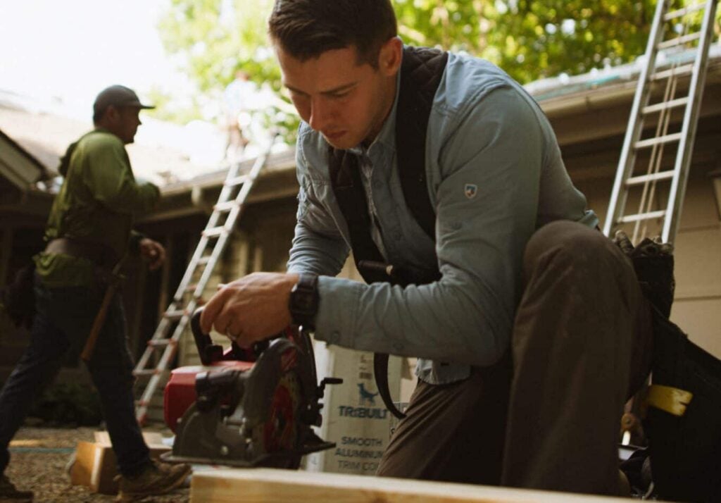 Residential contractor sawing wood at a home improvement job